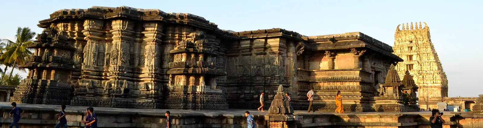 The carved walls of the Chennakeshava Temple at Belur and its gateway tower in evening light